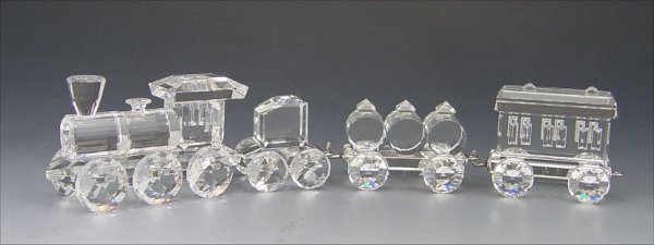 SWAROVSKI CRYSTAL 4 PC TRAIN: SWAROVSKI CRYSTAL 4 PC TRAIN: 1990 set originally sold in single box, designed by Gabriele Stamey, 6 3/8'' overall, includes Locomotive, Tender Car, Petrol Wagon and Wagon Carriage (Var 1). No box.