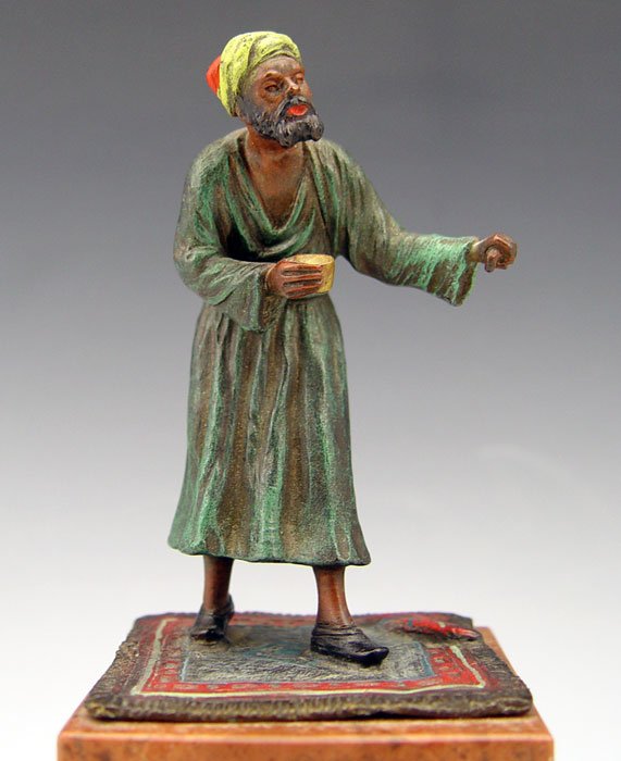 BERGMANN STYLE ORIENTALIST COLD PAINTED BRONZE: BERGMANN STYLE ORIENTALIST COLD PAINTED BRONZE: Figure of man holding cup, affixed to marble base. Measures 7 1/4" h overall x 2 3/4" x 2 3/4".