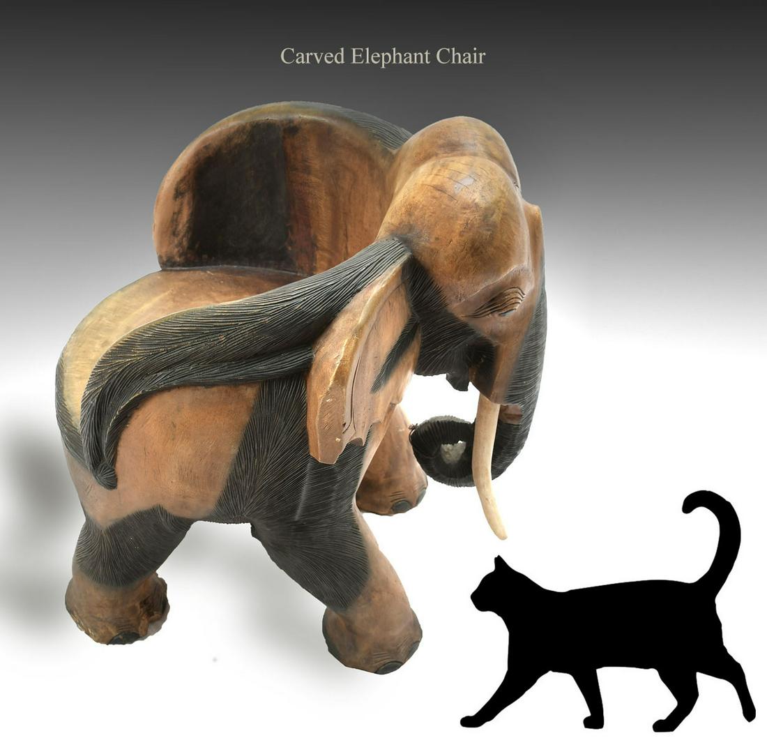 CARVED ELEPHANT CHAIR: CARVED ELEPHANT CHAIR: Carved of solid wood, having ebonized accents at body & trunk with inset tusks. Approx. 29.75" h x 28" l x 23.75" w.