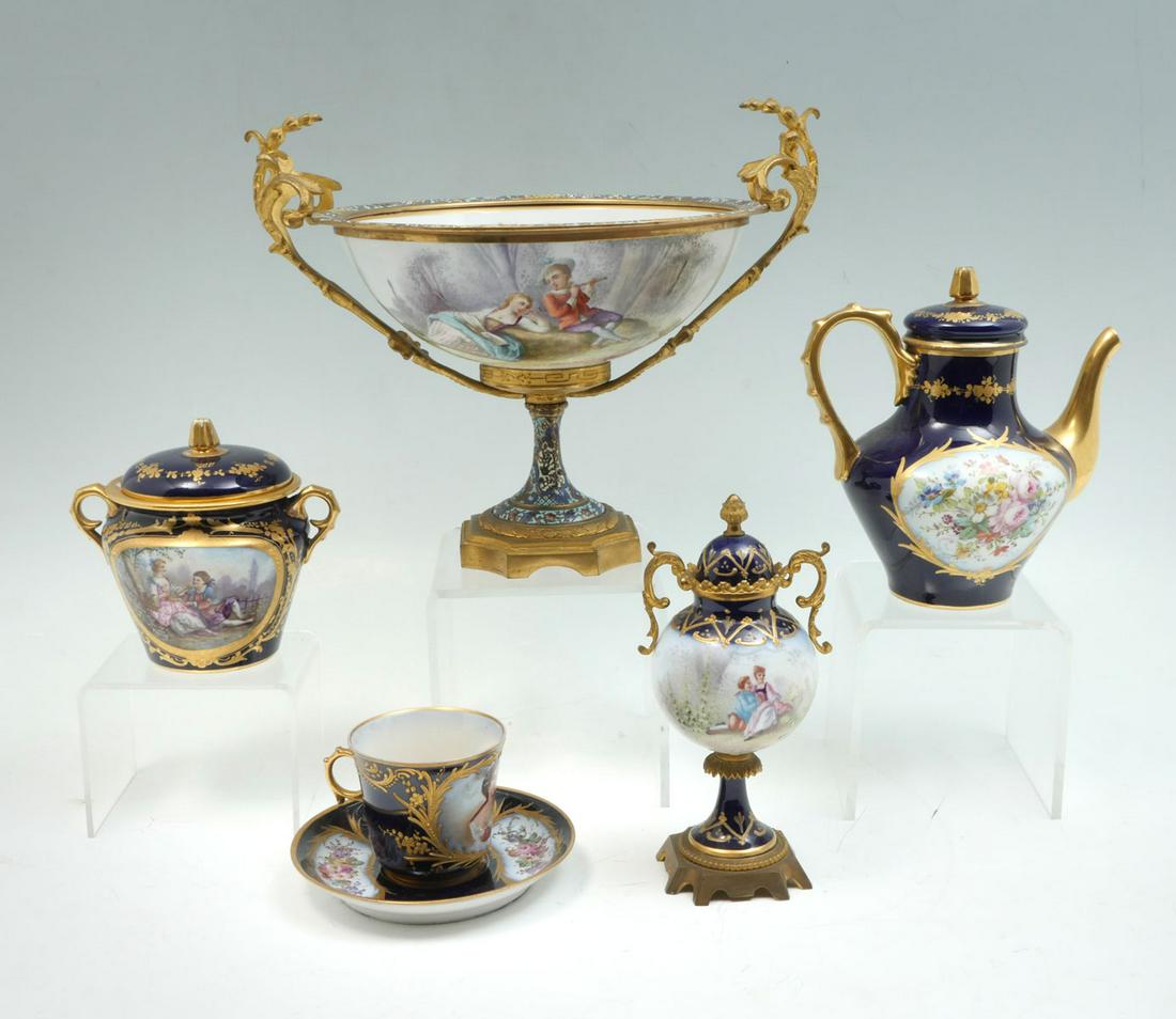6 PC. SEVRES PORCELAIN COLLECTION: 6 PC. SEVRES PORCELAIN COLLECTION: Comprising; Comprising; 1- Tea pot, 1- Cup, 1- Saucer, 1- Covered sugar bowl, 1- Covered urn, & 1- Large gilt & enameled metal mounted tazza with scrolling foliate h