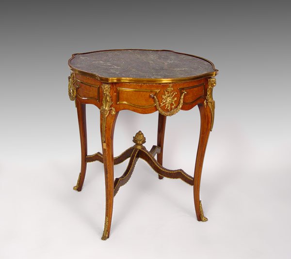 LATE VICTORIAN FRENCH STYLE MARBLE TOP TABLE: LATE VICTORIAN FRENCH STYLE MARBLE TOP TABLE: Green marble turtle top over burl veneer table frame. Over all gilt metal trim with swag and rams head ormolu. Central stretcher with twisted trim and gil