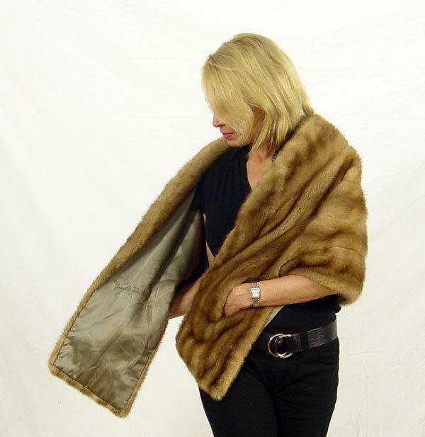 CARAMEL COLOR MINK FUR STOLE: CARAMEL COLOR MINK STOLE: Striplings Furl Salon of Fort Worth label. 19' length in back wraps around to 28" in the front.