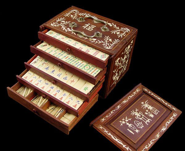 BONE INLAID MAH JONG SET: BONE INLAID MAH JONG SET: Floral bone inlay on wood 5 drawer box. Drawers are hidden by sliding removable front door. Bone and bamboo tiles. Approx. 148 tiles including blank tiles. Set also includes