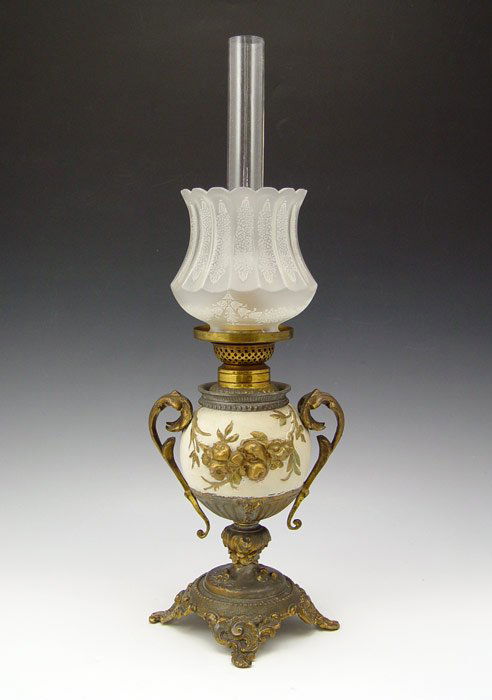 MINIATURE VICTORIAN P. A. MANUFACTURING OIL LAMP: MINIATURE VICTORIAN P. A. MANUFACTURING OIL LAMP: Urn shaped with white ground and applied gilt handles and swag decoration. Removable font. Period etched glass shade probably not original, though the