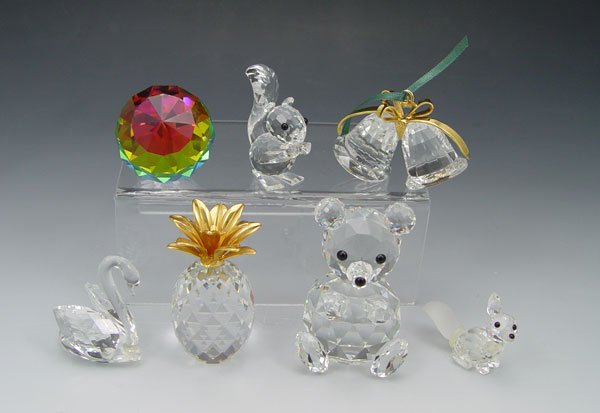 COLLECTION OF 5 SWAROVSKI FIGURINES: COLLECTION OF 5 SWAROVSKI FIGURINES: To include 1) Bear with black eyes and nose, 2 3/4". 2) Pineapple with gold toned top, 2 3/8". 3) Squirrel with black eyes and nose. 1 7/8" h. 4) Ball with multi c