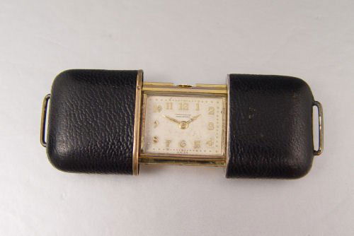 VINTAGE MOVADO ART DECO PURSE WATCH: VINTAGE MOVADO ART DECO PURSE WATCH: Gold plated watch, all original including the Art Deco crown. Leatherette exterior, opens and closes correctly. 1 3/4" length.