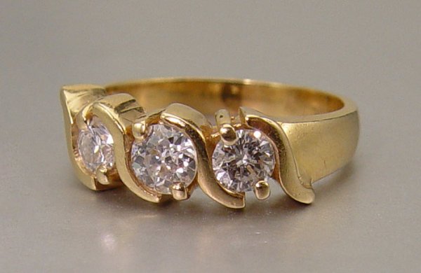 3 STONE DIAMOND RING 14K 4.82 grams Size 6: 3 STONE DIAMOND RING: 14K yellow gold ring with 1 old European cut diamond and 2 round brilliant cut diamonds. The Euro is approx. .34 Ct, SI1 clarity and G-H color. The brilliant cut are approx. .45 
