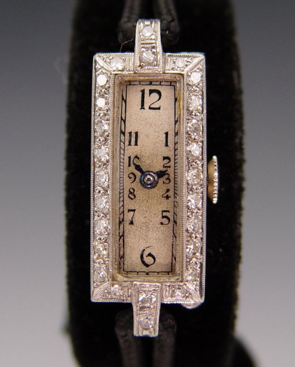 PAUL PORTINAUX PLATINUM & DIAMOND WATCH: PAUL PORTINAUX PLATINUM & DIAMOND WATCH: Platinum with estimated .25 carats of diamonds SI 1/2 clarity. 17 jewel Swiss made movement. Black nylon strap with standard gold filled fold over clasp.
