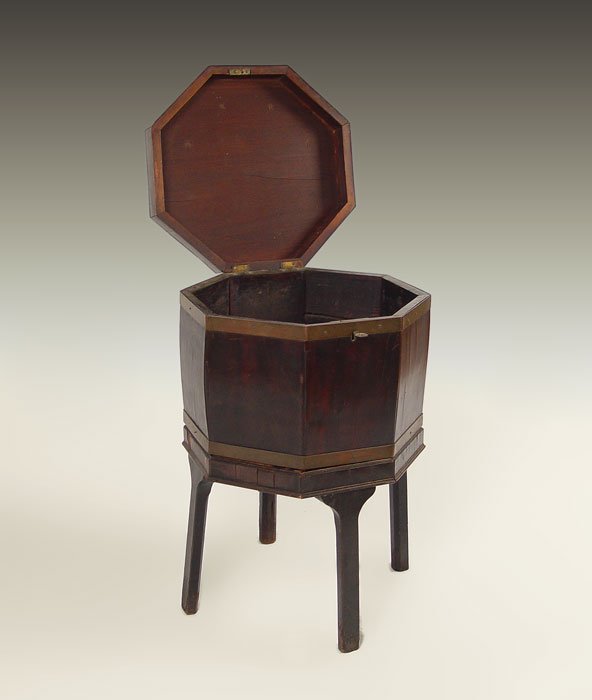EARLY 19th C CELLERETTE: EARLY 19th C CELLERETTE: Mahogany veneer, octagonal shape. Rests on base of 4 straight legs. 28"tall a 17" dia.