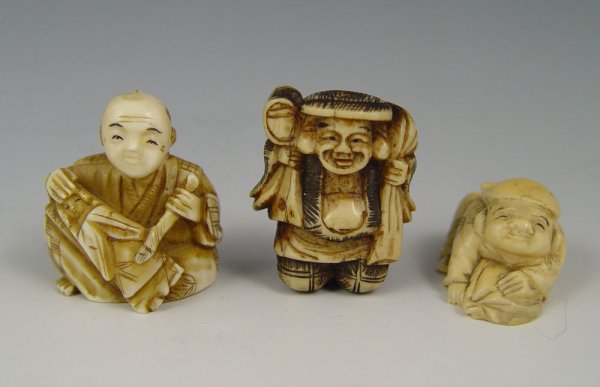 3 JAPANESE CARVED IVORY NETSUKE : COLLECTION OF 3 CARVED IVORY NETSUKES: To include 1) Man holding satchel, unsigned, 1 1/2". 2) Woodcarver with statue, unsigned, 1 1/2". 3) Boy laying down with pillow, unsigned, 1".