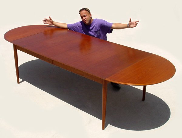 ARNE VODDER DANISH MODERN TEAK DINING TABLE: ARNE VODDER DANISH MODERN EXTENSION TABLE: Teak wood with banded top. Drop leaf table with 2 leaves. The legs are gently tapered. Table is 30'' wide with the leaves not in use. Each leaf is 21 3/4'' w