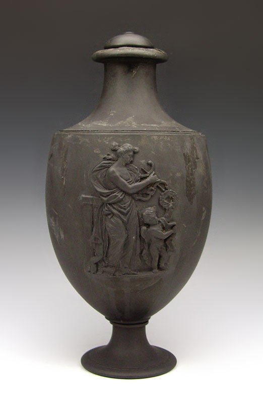 19TH C WEDGWOOD BLACK BASALT VASE CUPID & VENUS : 19TH C WEDGWOOD BLACK BASALT VASE: Deep relief images representing Cupid and Venus. 11 1/2"h. Please call for condition.