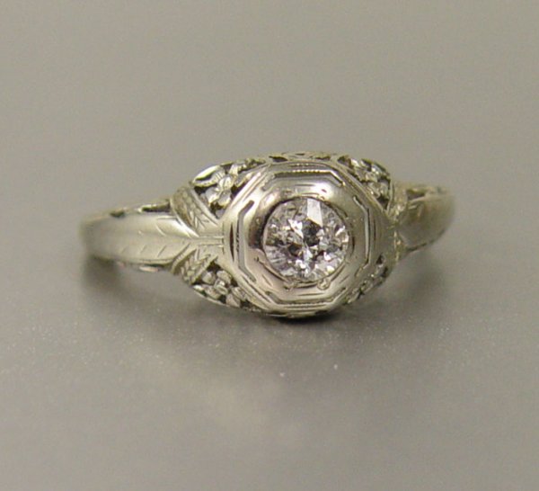 18K EDWARDIAN FILIGREE DIAMOND RING .30 CT 2.5 GR: 18K EDWARDIAN FILIGREE DIAMOND RING: 18K white gold Edwardian filigree ring contains one old mine cut diamond. Weight: .30 Ct. Approx. Rated I1 in clarity and H-I in color. The diamond is bezel set. W
