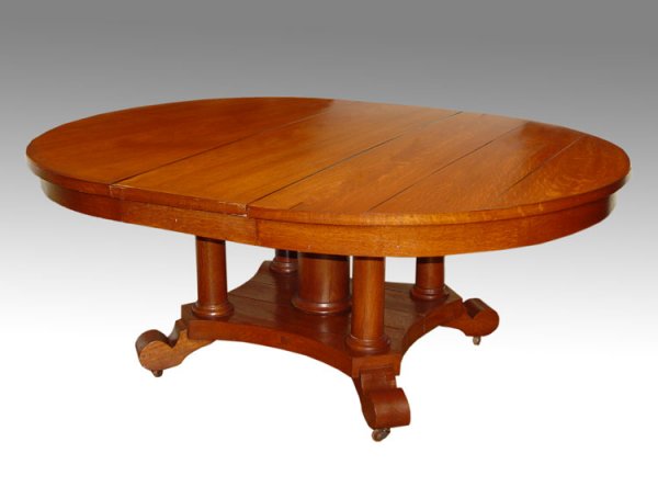 19th C OAK EXPANDABLE DINNING TABLE: A GRAND LATE 19th C OAK EXPANDABLE DINNING TABLE: Round top on a 5 column base. 30" tall x 59" dia., expands to 96" oval with the 2 leaved in place.