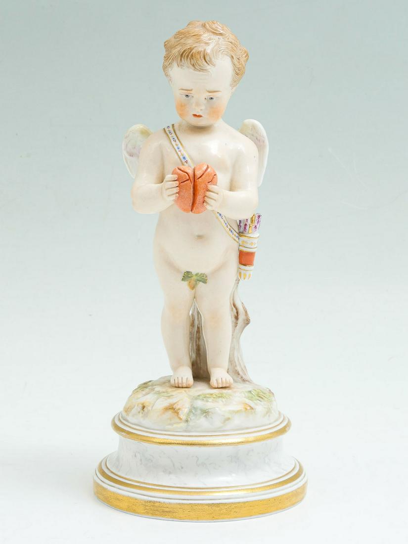 MEISSEN CHERUB WITH BROKEN HEART: MEISSEN CHERUB WITH BROKEN HEART: Meissen porcelain cherub, having a sad expression due to the broken heart that lies in hand. Blue crossed swords and incised marks at underside. Approx. 8'' h x 3.75'