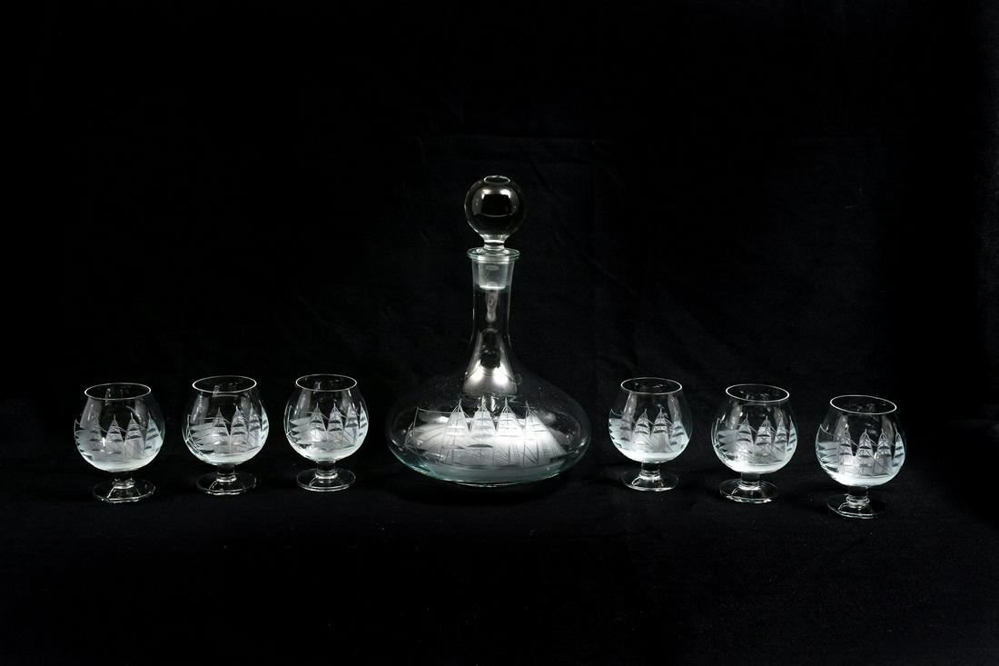 ORREFORS SHIP ENGRAVED DECANTER & SIX GLASSES: ORREFORS SHIP ENGRAVED DECANTER & SIX GLASSES: Comprising; 1- Decanter, & 6- Snifters. All having etched sailboats. Decanter Approx. 10.25'' h x 7'' w.