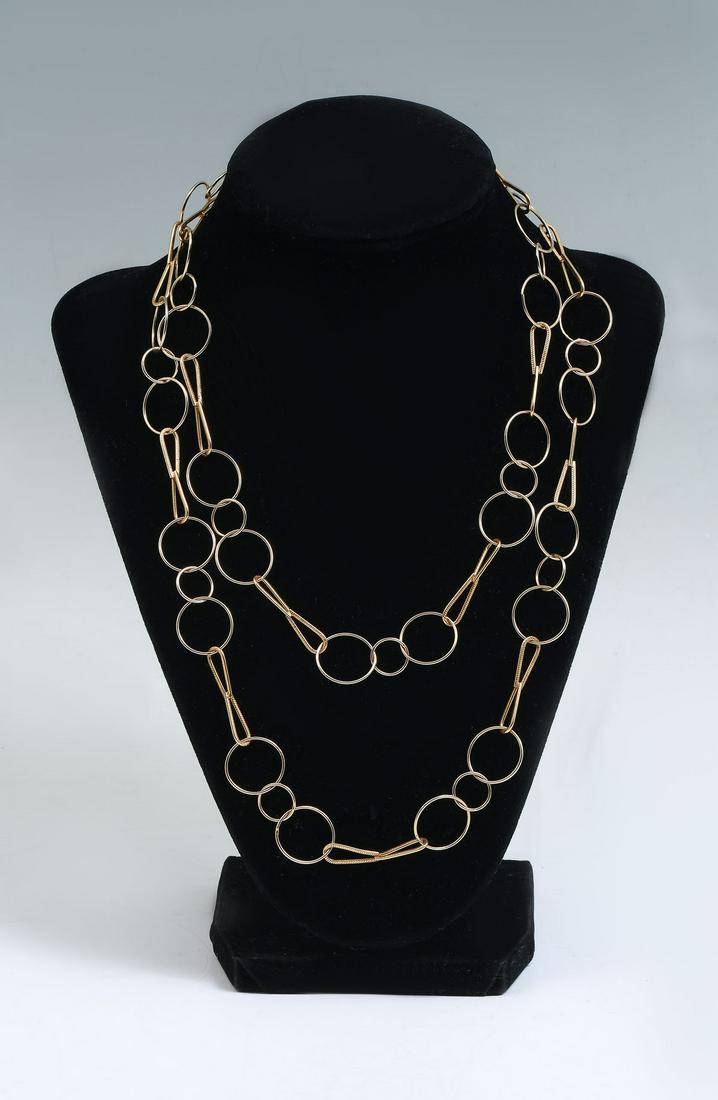 42'' 18K CIRCLE AND BOWTIE LINK NECKLACE: 42'' 18K CIRCLE AND BOWTIE LINK NECKLACE: This circle and bowtie link necklace is in the style of Ippolita and measures 42'' long. It is 18k yellow gold and the links alternate between 3 sets of inter