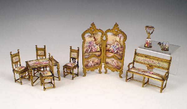MINIATURE AUSTRIAN ENAMEL SALON SUITE: MINIATURE AUSTRIAN VIENNESE ENAMEL SALON SET: 7 pieces plus. The two panel hinged SCREEN (5''h. x 4'') with hand painted panels front and verso. SETTEE (2 1/2'' x 3 1/3''), 4 CHAIRS (2 3/4''), and TAB