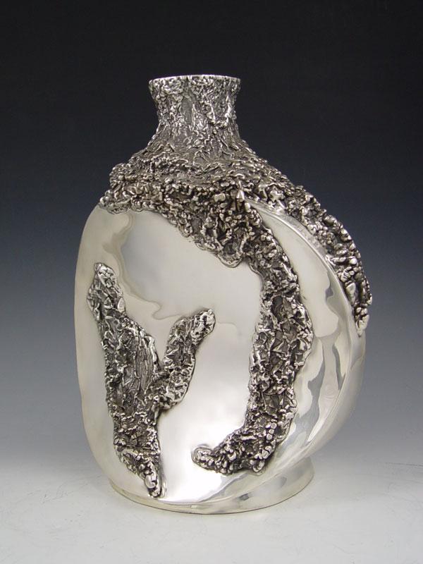 D'ARGENTA SCULPTURAL VASE: D'ARGENTA SCULPTURAL VASE: Silverplated vase designed by Sima / Simone Abraham. Made in Mexico. 12" tall x 10 1/2" at the widest.