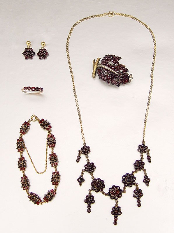 5 PIECE ANTIQUE GARNET JEWELRY: 5 PIECE ANTIQUE GARNET JEWELRY: The necklace having 7 rosettes with dangles. Bracelet having 10 rosettes, 6 1/2"l. Grape cluster brooch of garnets and seed pearls, 1 1/2"l. Ring with 5 garnets. Post e