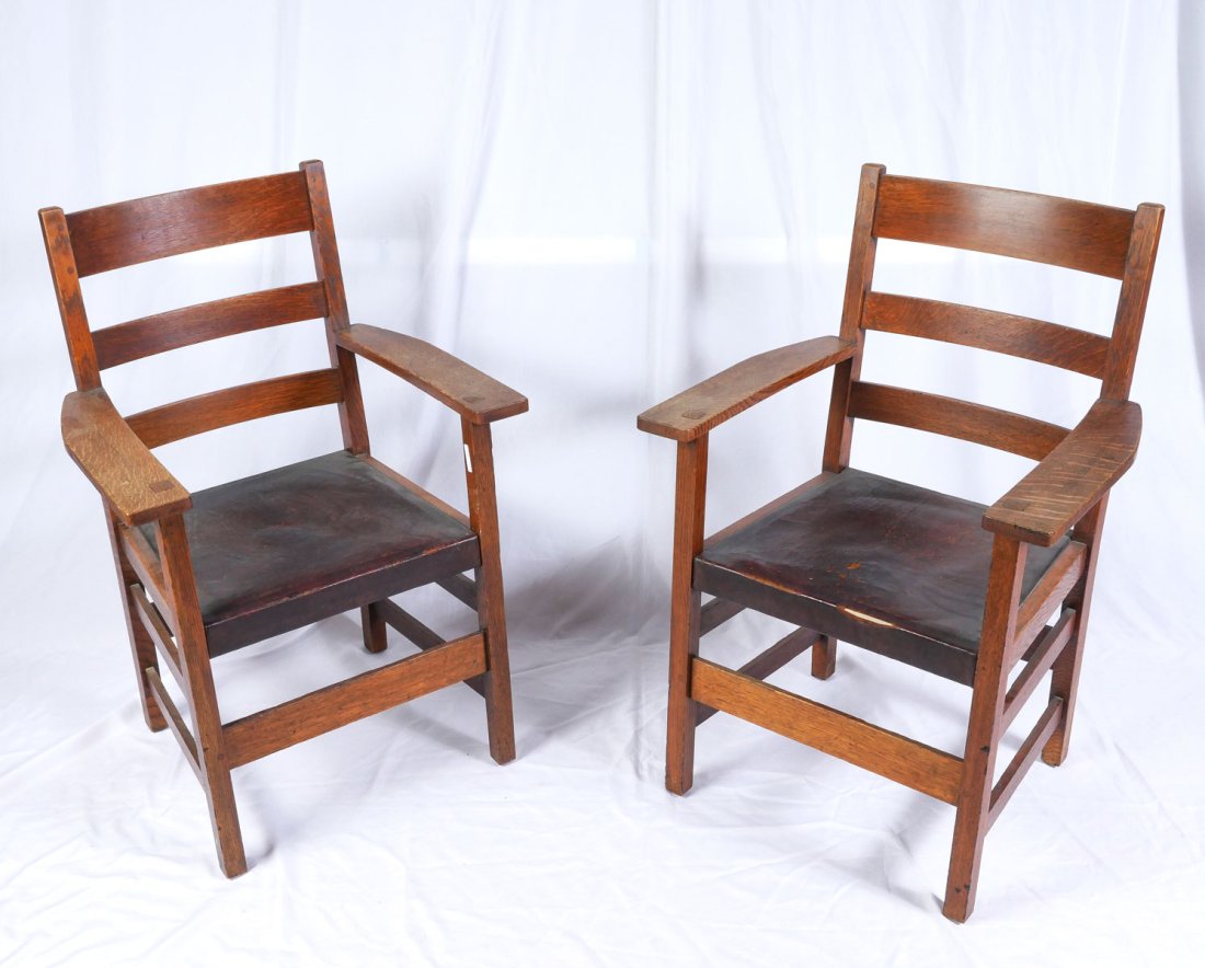 PAIR OF L & JG STICKLEY OAK ARMCHAIRS: PAIR OF L & JG STICKLEY OAK ARMCHAIRS: Pair of slat back L & JG Stickley armchairs. Signed at lower verso with Handcraft decal. Original leather seats. Approx. 37.5" h x 24.75" l x 23" w.