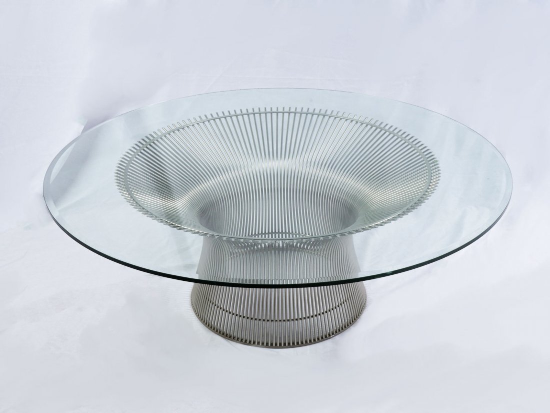 WARREN PLATNER COFFEE TABLE: WARREN PLATNER COFFEE TABLE: Warren Platner table with a chromed & flared wire base with a round glass top. Approx. 15" h x 42.25" w.