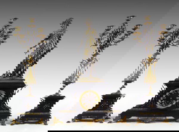 FRENCH FIGURAL BRONZE CLOCK GARNITURE SET: FRENCH FIGURAL BRONZE CLOCK GARNITURE SET: Silvered bronze figure of a maiden with birds at her feet over black onyx base with ormolu mounts and engraved designs. Signed C. H. Gautier Fils on face and