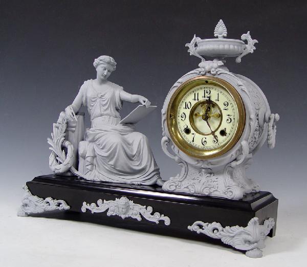 NEW HAVEN FIGURAL MANTLE CLOCK: NEW HAVEN FIGURAL MANTLE CLOCK: Metal case featuring maiden drawing, painted grey with grey feet and accents. Enameled face with Arabic numerals, open escapement, marked New Haven. Time and strike mov