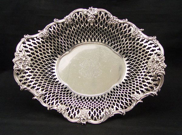 HOWARD & CO. STERLING RETICULATED BASKET: HOWARD & CO. STERLING RETICULATED BASKET: Monogrammed interior, dedication on base. Approx. 14.6 troy oz. 2 1/2" h. x 11 1/2" x 8 7/8".