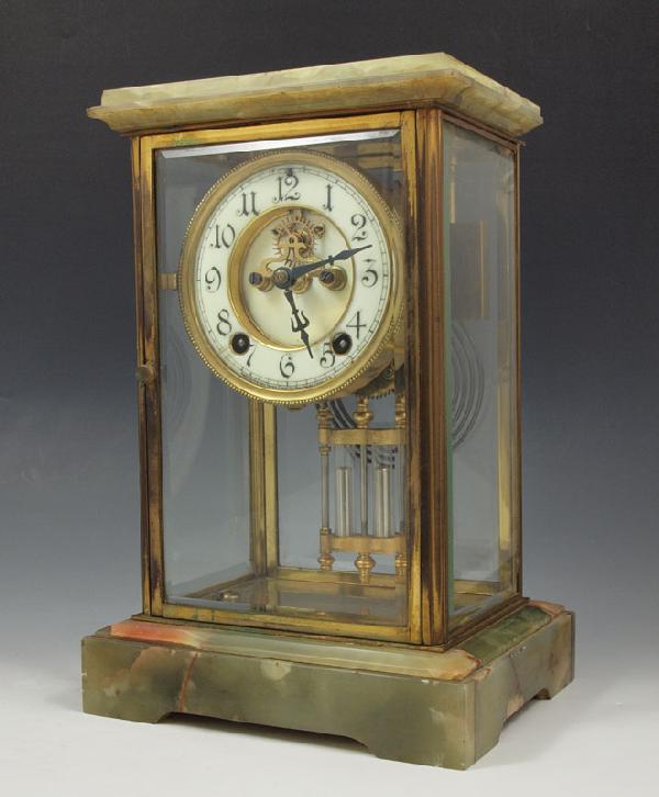 NEW HAVEN ONYX CRYSTAL REGULATOR CLOCK: NEW HAVEN ONYX CRYSTAL REGULATOR CLOCK: Onyx top and base with brass and beveled glass sides. New Haven time & strike movement with open escapement on enameled face. Arabic numerals. Faux mercury pend