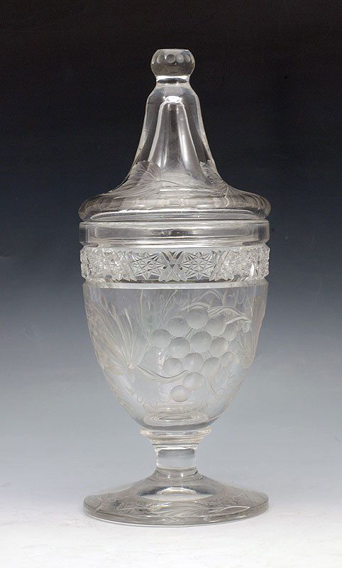 SIGNED TUTHILL BRILLIANT CUT GLASS 'VINTAGE" COVER: TUTHILL INTAGLIO GRAPES OR VINTAGE PATTERN AMERICAN BRILLIANT PERIOD CUT GLASS COMPOTE: Covered pedestal jar, 10 1/2" tall. Geometric border. Acid etched Tuthill.