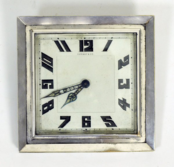 TIFFANY & CO. ART DECO DESK CLOCK: TIFFANY & CO. ART DECO DESK CLOCK: Art deco design marked Tiffany & Co. France on face. Framed in silverplate. Metal face with Arabic numerals. Stamped France on back as well. 6 1/2" square frame.