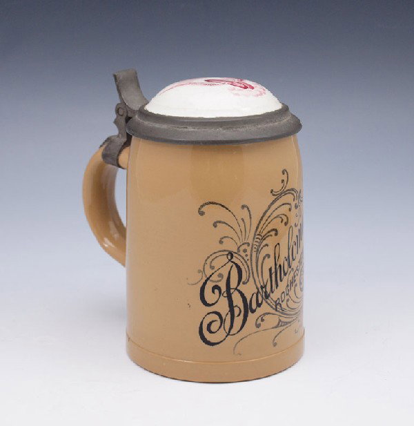 BARTHOLOMAY'S BREWERY VILLEROY & BOCH STEIN: BARTHOLOMAY'S BREWERY VILLEROY & BOCH STEIN: Advertising stein for Bartholomay's Brewery Rochester. 4/10 Liter PUG stein with PUG lid featuring logo of wheel with wings. Green Villeroy & Bach stamp wi