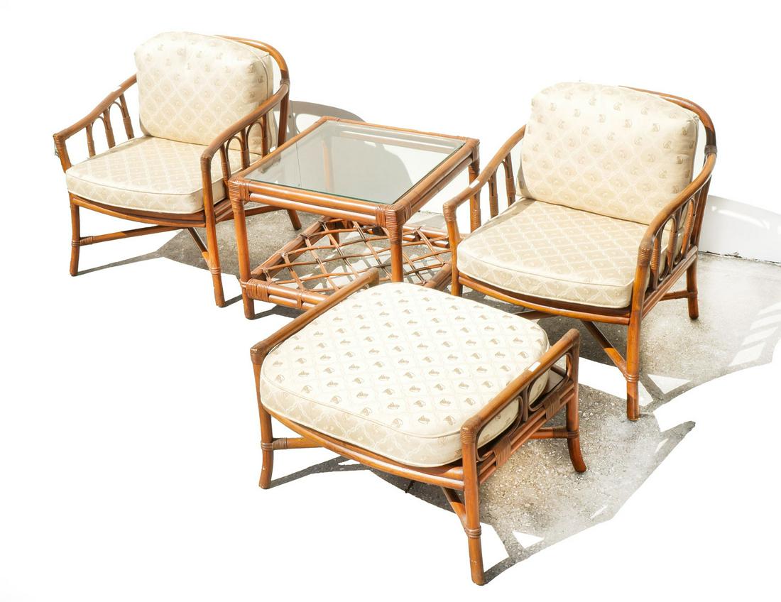 FOUR PIECE FICKS & REED BAMBOO RATTAN GROUPING: FOUR PIECE FICKS & REED BAMBOO RATTAN GROUPING: Two matching armchairs, an ottoman, and a glasstop lamp table. Chairs measure 30'' in height and 20'' deep. Ottoman is 18.5'' in height, 27'' wide, 21.5
