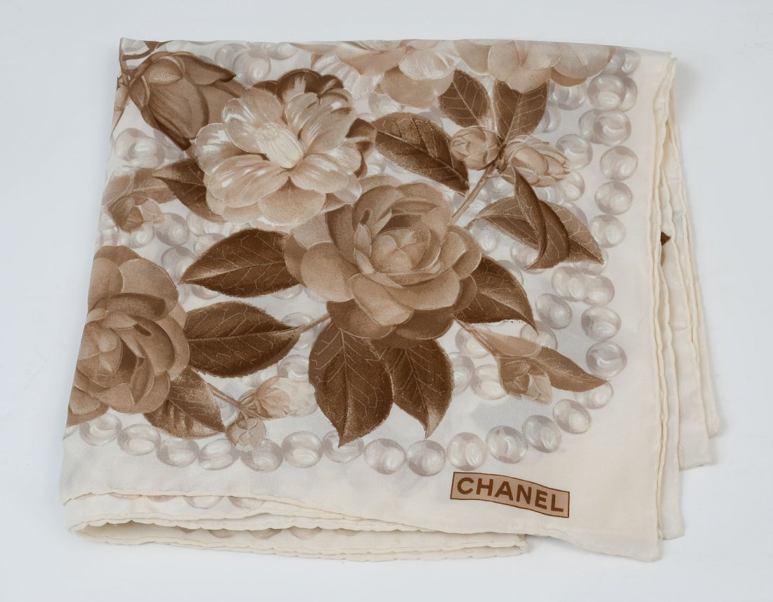 CHANEL SILK CAMELLIA SCARF IN BROWN TONES: CHANEL SILK CAMELLIA SCARF IN BROWN TONES: These soft brown tones compliment most wardrobes nicely. Silk Chanel scarf with hand sewn hem measures approx 34'' x 34''. Sold with Neiman Marcus box, CHANE