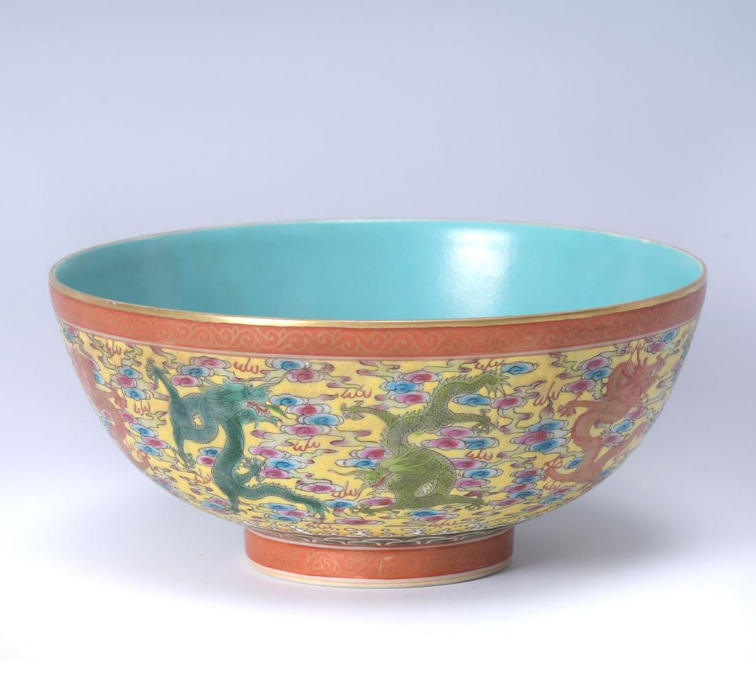 CHINESE FAMILLE ROSE IMPERIAL DRAGON BOWL: CHINESE FAMILLE ROSE IMPERIAL DRAGON BOWL: Finely enameled Chinese bowl, having a yellow ground with Dragons amongst stylized clouds & fire. Turquoise interior, blue stamp at underside. Approx. 3'' h