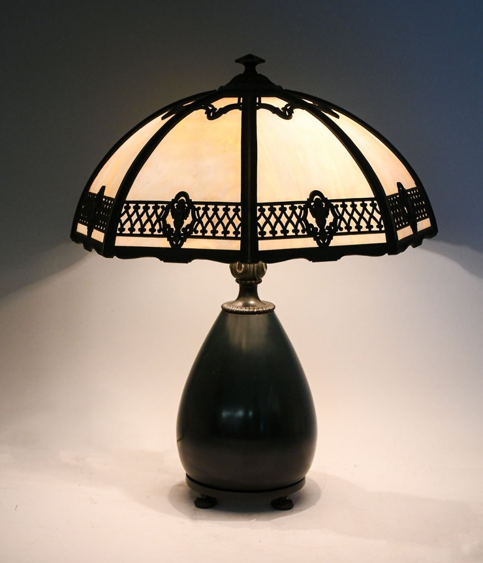 BRADLEY & HUBBARD CURVED SLAG GLASS FILIGREE LAMP: BRADLEY & HUBBARD CURVED SLAG GLASS FILIGREE LAMP: Bradley & Hubbard 2 light patinated base, raised on ribbed circular feet. Octagonal curved slag glass shade with Urn & geometrical filigree border. S