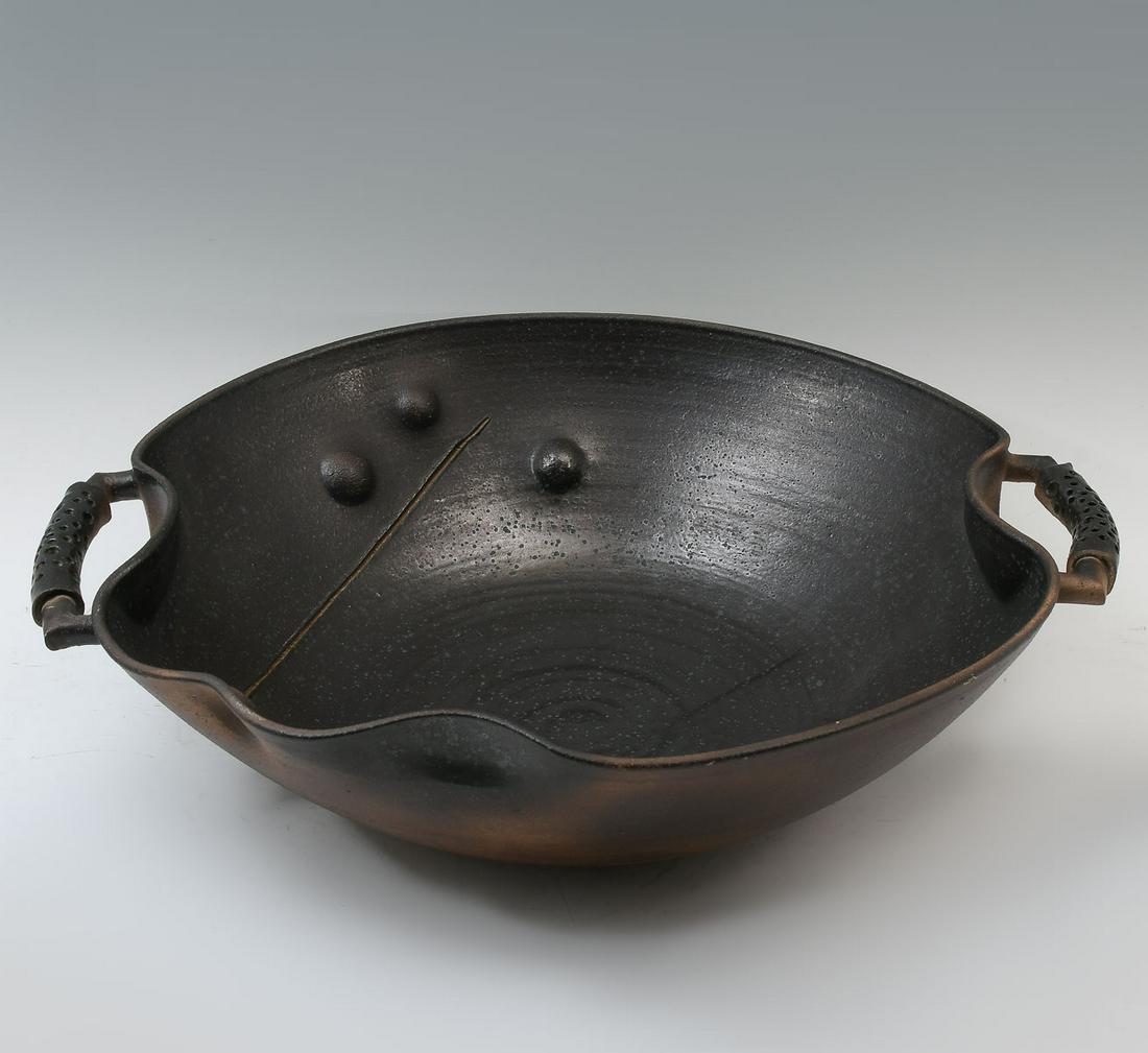 LARGE JAPANESE? STUDIO ART POTTERY CHARGER: LARGE JAPANESE? STUDIO ART POTTERY CHARGER: Large double handled pottery charger with pierced handles. Dimpled with an incised line, partial black salt glaze. Attached square impressed with artist's m