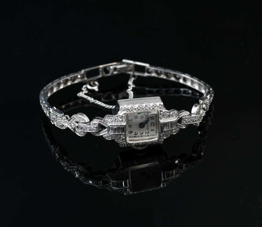 LADIES PLATINUM & DIAMOND HAMILTON WATCH: LADIES PLATINUM & DIAMOND HAMILTON WATCH: Ladies platinum watch is set with 8 baguette cut diamonds at 0.14 carat total weight, H-I color/VS-2 to SI-2 clarity. Fifty-eight single cut diamonds at 1.00 