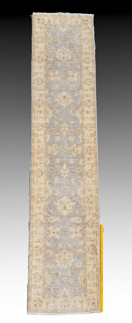 PAKISTANI HAND KNOTTED WOOL RUNNER, 2'8" X 11'8": This: PAKISTANI HAND KNOTTED WOOL RUNNER, 2'8" X 11'8": This long runner has pastel coloring with a pale grey field with ivory and pale yellow motifs and borders.