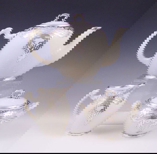LENOX CAC AMERICAN BELLEEK SILVER OVERLAY TEA SET: LENOX AMERICAN BELLEEK SILVER OVERLAY 3 PIECE TEA SET: Ca. 1906-1924. Art Nouveau silver design over fine American Belleek porcelain. Teapot, creamer and covered sugar. All three pieces bear the artis
