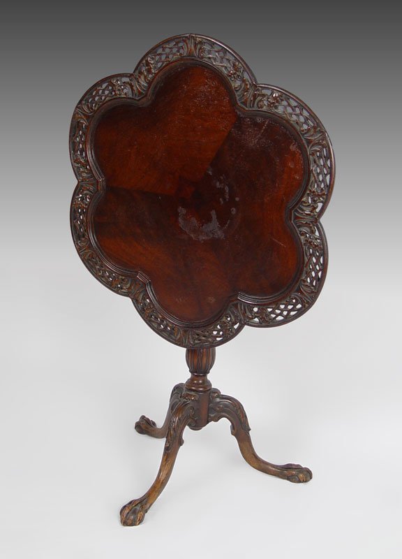 MAHOGANY BALL CLAW FOOT TILT TOP TEA TABLE: CARVED MAHOGANY BALL AND CLAW FOOT TILT TOP TEA TABLE: Scalloped pierce carved top, ball and claw feet. Top is 28" dia.
