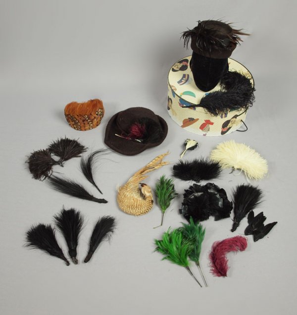 HAT BOX FULL OF MILLINERY FEATHERS & VINTAGE HATS: HAT BOX & MILLINERY FEATHERS & HATS: Two vintage felt hats, a pheasant band hat, and 11 feather adornments. Sold with the hat box.