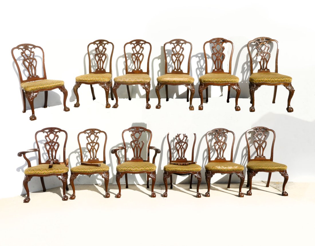 LATE 19TH CENTURY CHIPPENDALE STYLE CARVED CHAIRS: 12 LATE 19TH CENTURY CHIPPENDALE STYLE CARVED CHAIRS: Comprising; 2- Armchairs & 10- Side chairs. All having pierced intertwining back splats. Raised on cabriole legs with carved knees & claw on ball 