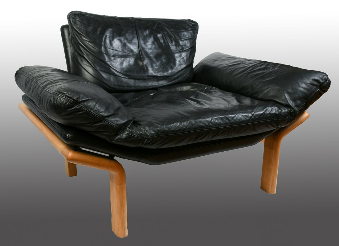 MODERN KOMFORT DANISH LEATHER CHAIR: MODERN KOMFORT DANISH LEATHER CHAIR: Mid-century modern "Komfort", Danish chair, in black leather. Blonde oak frame. Approx. 29" h x 44" l x 33" d.