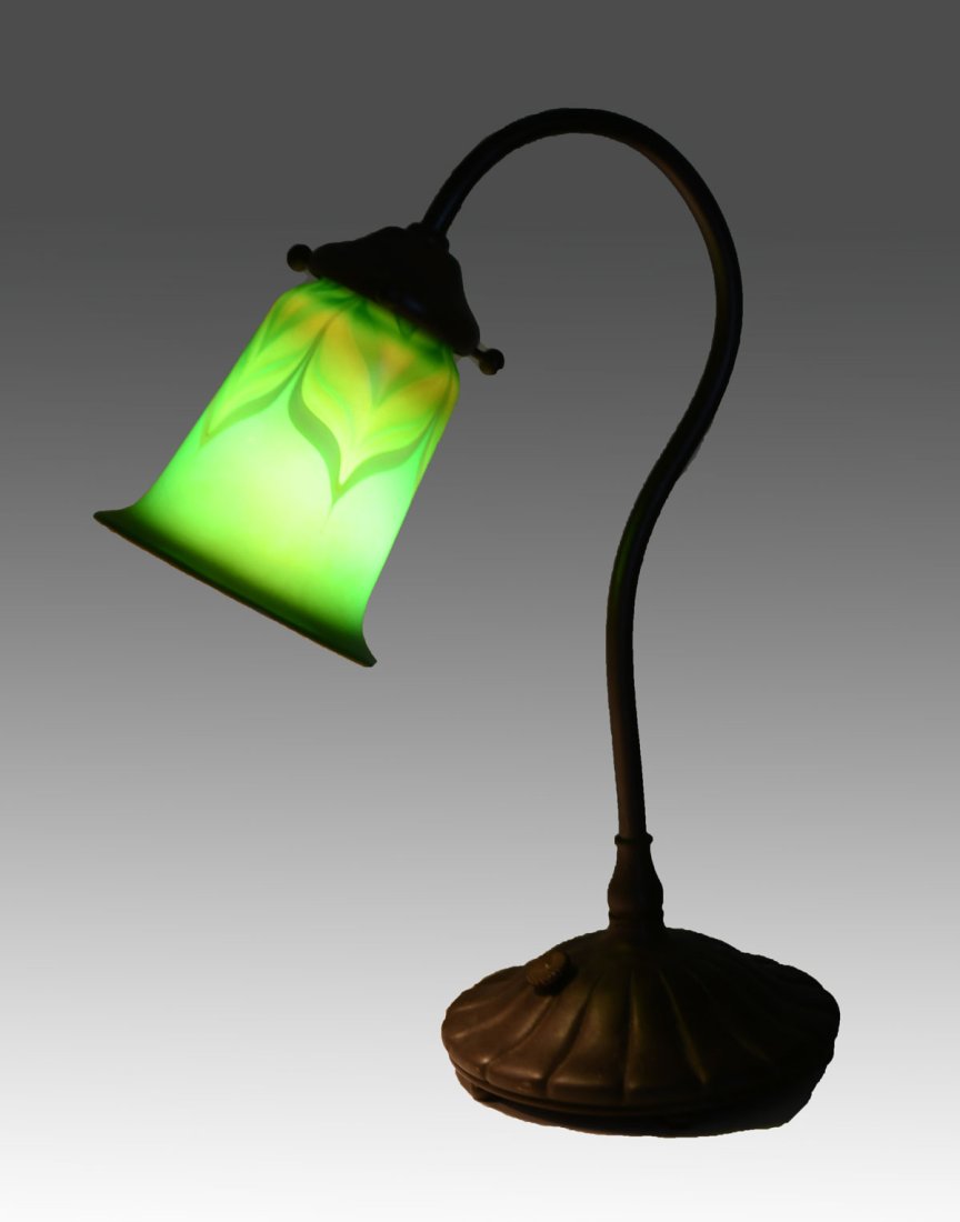 BUFFALO STUDIOS ART METAL FLORIFORM LAMP: BUFFALO STUDIOS ART METAL FLORIFORM LAMP: Tiffany style bronze lamp with an Orient & Flume feather pulled art glass shades. Impressed marks at the underside. Approx. 13.5" h x 10.25" l x 5.5" w.