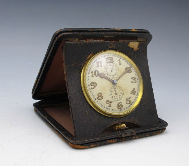TIFFANY & CO. 8 DAY TRAVEL ALARM CLOCK: TIFFANY & CO. 8 DAY TRAVEL ALARM CLOCK: 8 day movement with secondary second and alarm time hands. Marked Tiffany & Co. on face, Sterling Silver on back cover. Leather case. 1" h. x 4 1/8" square.