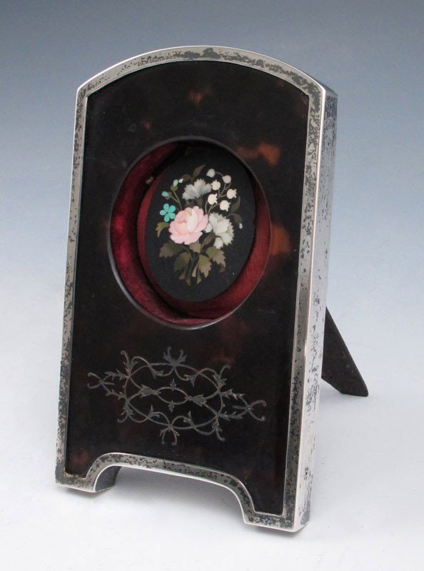 MICRO MOSIAC IN ENGLISH STERLING FRAME : MICRO MOSIAC IN ENGLISH STERLING FRAME: Inlaid floral design micro mosaic framed in tortoise shell and Charles & Richard Comyns 1929 English silver frame with leather easel back. 4 3/4" h. x 3" x 1".