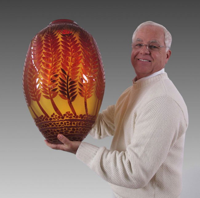 DUNCAN McCLELLAN ART GLASS VASE MONUMENTAL 22": McCLELLAN, Duncan, (American 1955-): Monumental art glass vase, Etched and sculpted with fern stems, leaves and rocks. Red to amber glass. Signed on base. 22 1/2'' h. x 13 1/2''.