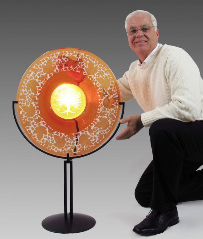 DUNCAN McCLELLAN ART GLASS RONDELETTE SCULPTURE: McCLELLAN, Duncan, (American 1955-): Etched and sculpted rondelette with maple leaf rim and maple tree interior. Lamp verso creates the effect of continuous sun light. Metal stand. 35 3/4" h. x 22" x